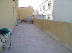 This double house for sale in Larnaca has enough car parking space to the side of the house for two cars. 